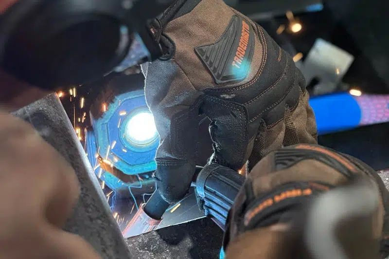 Automotive technician welding radiator support