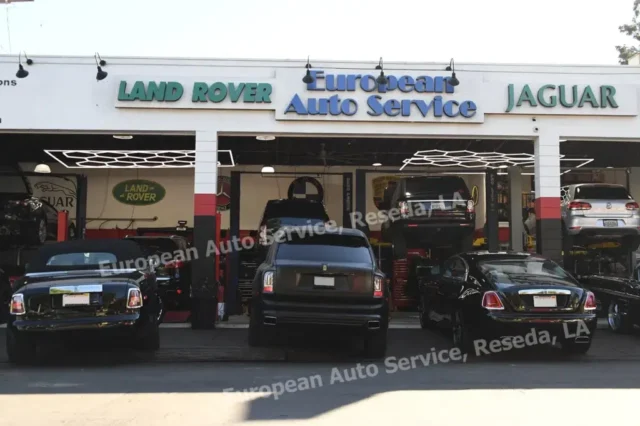 Several Rolls-Royce vehicles at the entrance of European Auto Service in Reseda, LA, with service bays open and vehicles on lifts