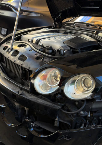 Bentley Engine Repair with Front-End Disassembly at European Auto Service Open hood view of a Bentley with front bumper removed, showing engine components during repair at European Auto Service in Los Angeles