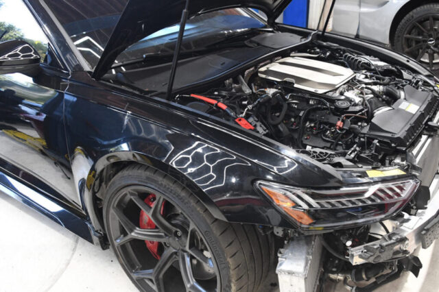 Detailed View of Audi RS6 Engine Service at Reseda Auto Shop Audi RS6 engine with open hood during repair and diagnostics