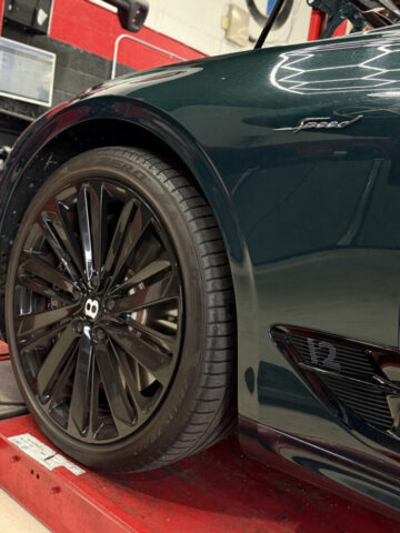 Bentley Continental GT Speed Wheel Service in Los Angeles Green Bentley Continental GT Speed on alignment rack at European Auto Service Reseda showing Pirelli P Zero tires