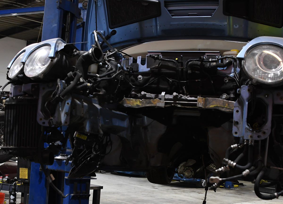 Bentley front end fully disassembled showing exposed wiring harness and electrical modules during service at European Auto Service