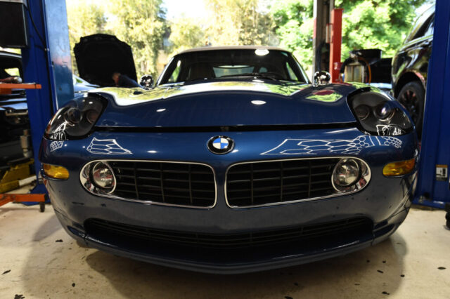 Front view of Topaz Blue BMW Z8 between service lifts at European Auto Service in Reseda, California, ready for specialist maintenance
