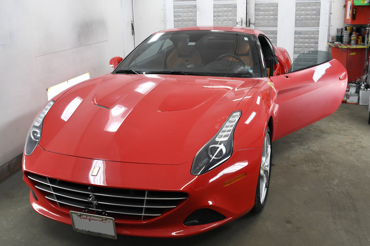 Red Ferrari California T with tan interior and open door after completed service at European Auto Service