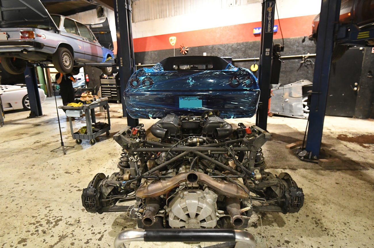 Ferrari on lift with complete engine transmission and rear subframe assembly removed during major overhaul at European Auto Service in Reseda