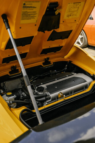 lotus-elise-engine-bay-repair-reseda Open engine bay of yellow Lotus Elise showing inline-4 engine during service at European Auto Service in Reseda, California