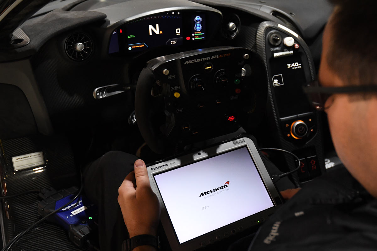 Technician running McLaren Diagnostic System on Panasonic tablet inside McLaren P1 GTR cockpit at European Auto Service