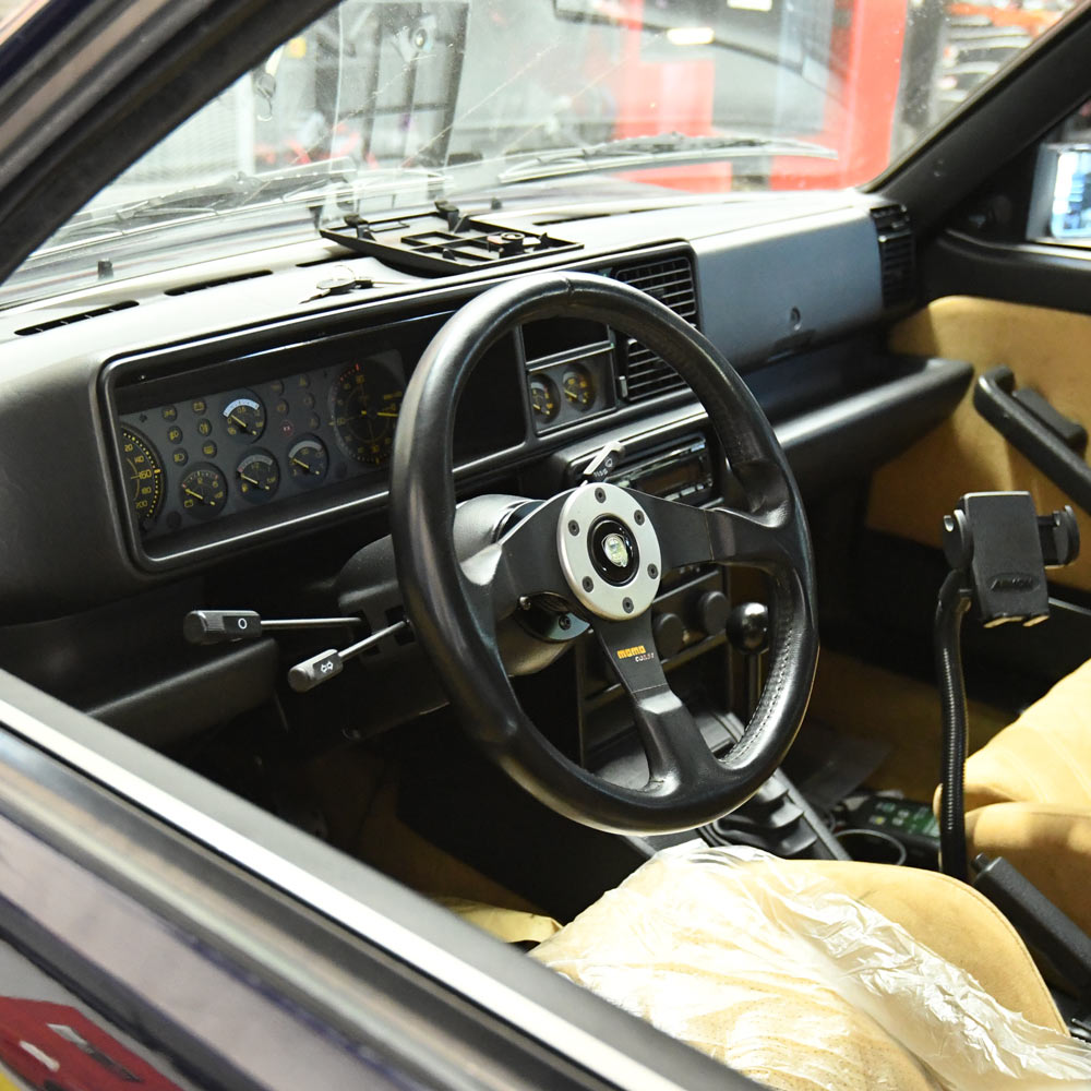 Lancia Delta Integrale rally interior with performance steering wheel and gauges