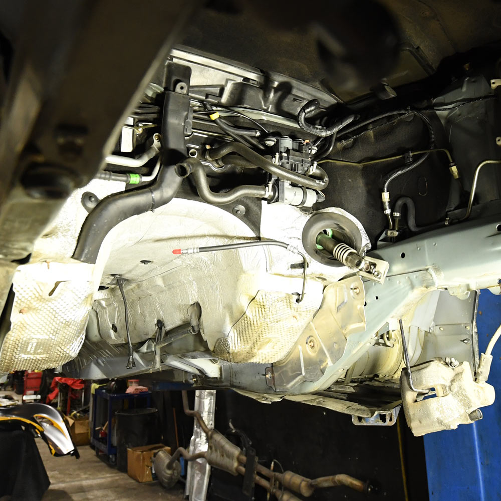 Underbody transmission inspection and drivetrain diagnostics on vehicle lift