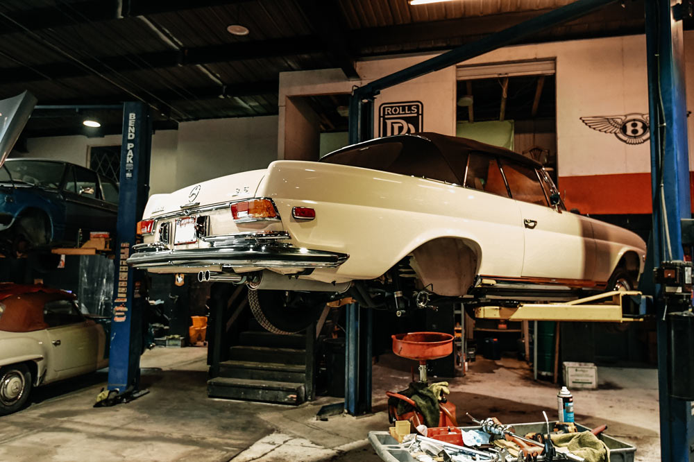 Mercedes 280SE Cabriolet on lift during rear axle seal replacement