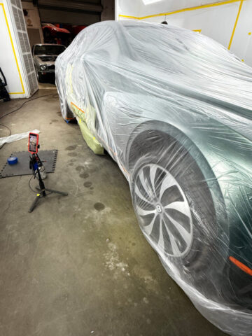 Bentley Flying Spur paint process with video documentation Bentley Flying Spur masked for partial paint refinishing with video documentation in progress