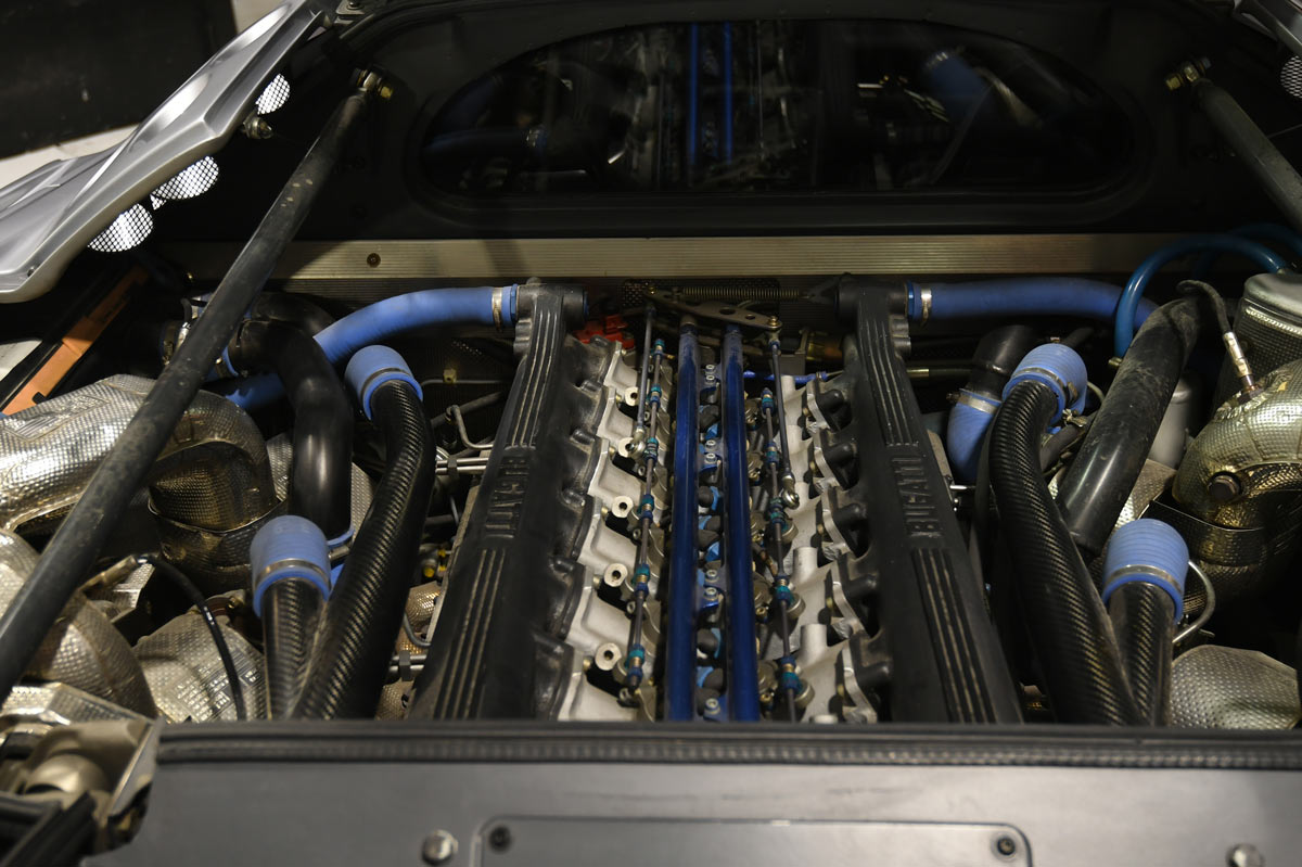 Bugatti EB110 SuperSport 3.5L quad-turbo V12 60-valve engine bay during service in Reseda