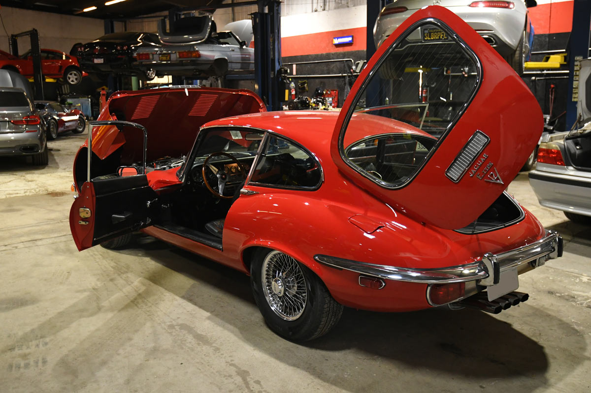 Jaguar E-Type with doors and rear hatch open for inspection access