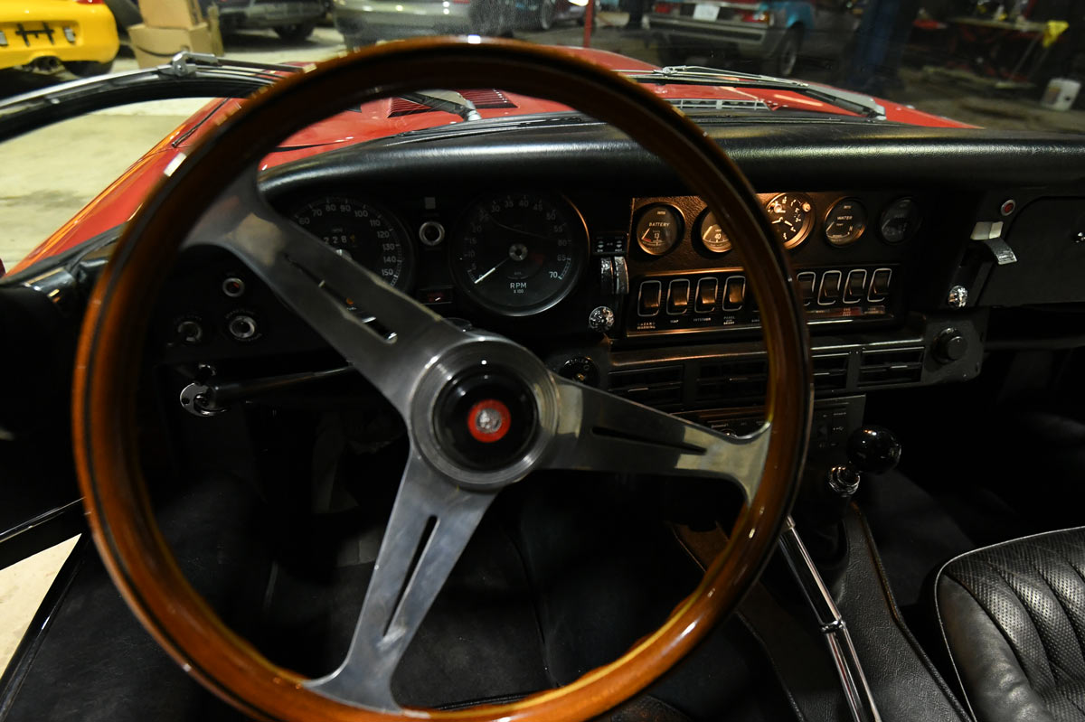 Jaguar E-Type instrument cluster and wood-rim steering wheel detail