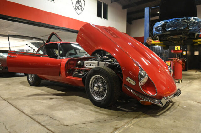E-Type bonnet tilted for engine access Jaguar E-Type V12 with forward-tilting bonnet open for engine access